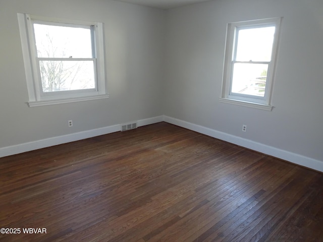 unfurnished room with dark hardwood / wood-style floors