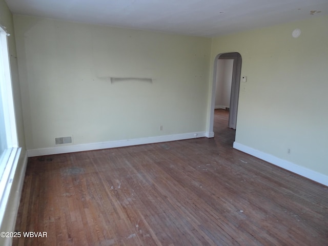 empty room with dark hardwood / wood-style flooring