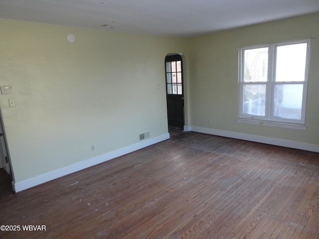 unfurnished room with dark hardwood / wood-style floors