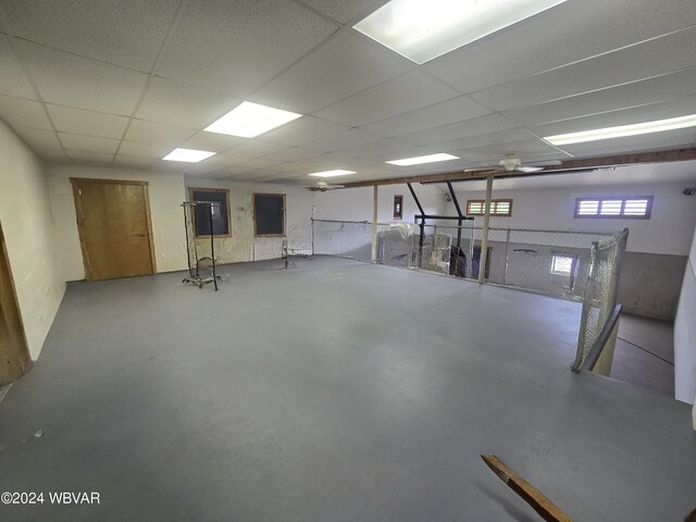 basement with a paneled ceiling