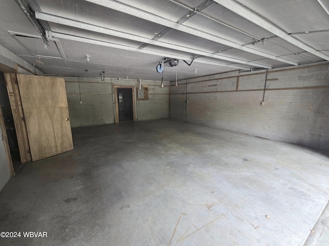 garage with electric panel and a garage door opener