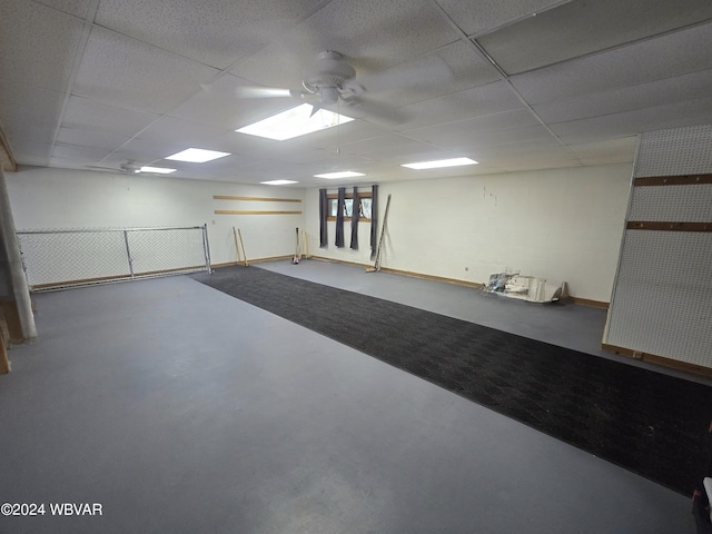 interior space featuring a paneled ceiling and ceiling fan