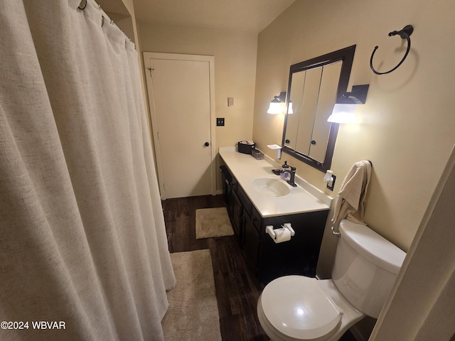 bathroom featuring wood-type flooring, vanity, and toilet