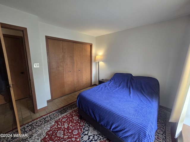 tiled bedroom featuring a closet