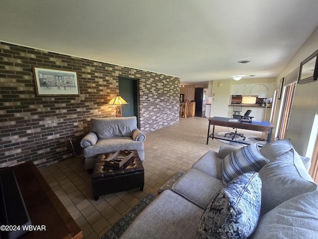 living room featuring brick wall