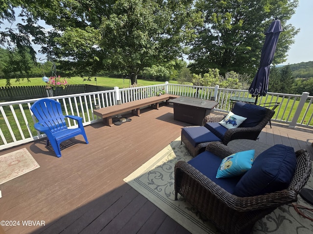 deck with a yard and an outdoor living space with a fire pit