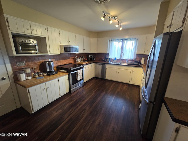 kitchen with sink, stainless steel appliances, tasteful backsplash, dark hardwood / wood-style floors, and white cabinets