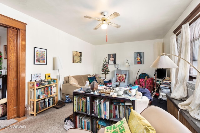 sitting room with a ceiling fan and carpet flooring
