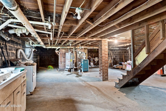 unfinished basement featuring washer and dryer, a heating unit, and water heater