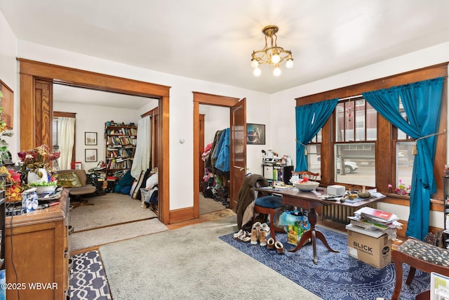 home office with carpet flooring and a notable chandelier