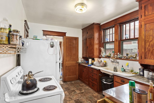 kitchen featuring white appliances, tile countertops, and stone finish flooring