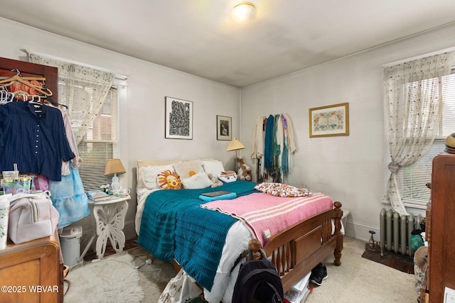 bedroom featuring radiator heating unit and carpet
