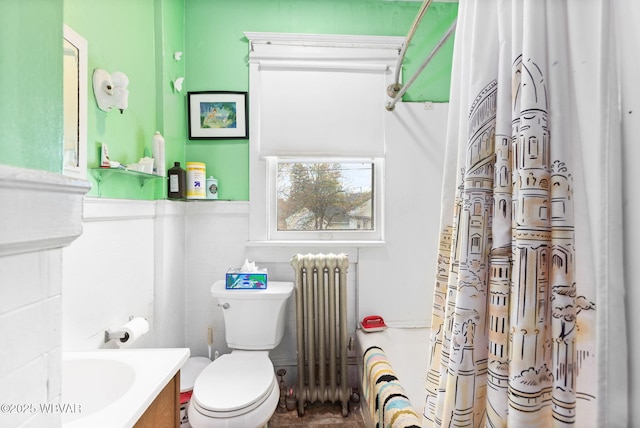 full bath with vanity, toilet, radiator heating unit, tile walls, and a shower with curtain
