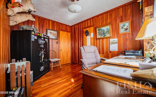 office space with wood finished floors and wood walls