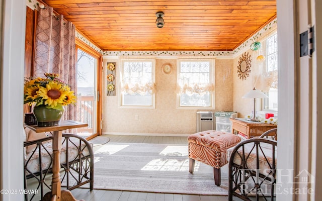 sitting room with a healthy amount of sunlight, wooden ceiling, and wood finished floors