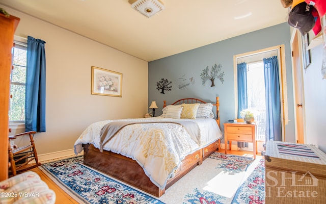 bedroom featuring baseboards and wood finished floors