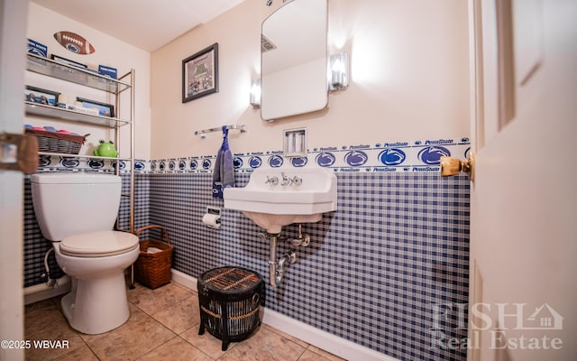 bathroom featuring tile patterned flooring and toilet