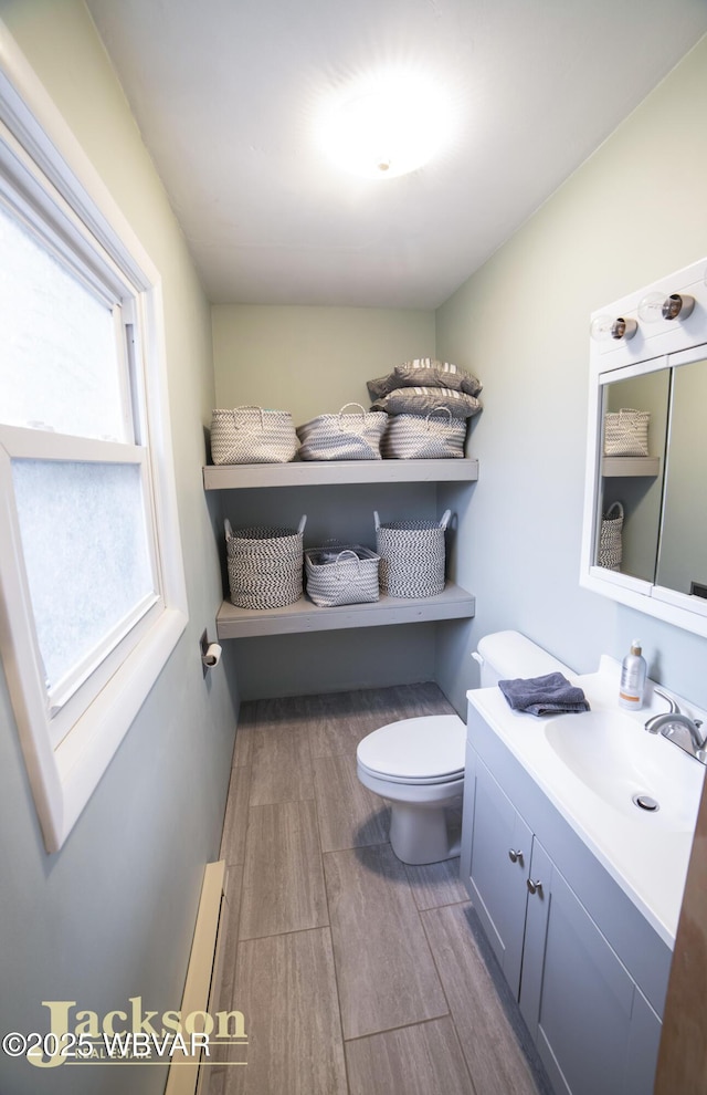 bathroom with vanity, a baseboard radiator, and toilet