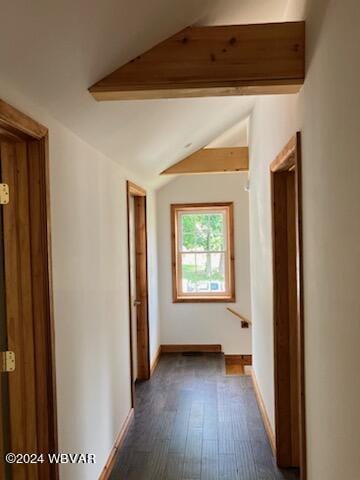 hallway with dark wood-style flooring, lofted ceiling with beams, and baseboards