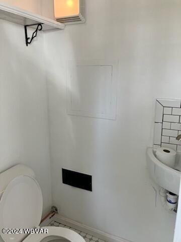 half bathroom featuring toilet