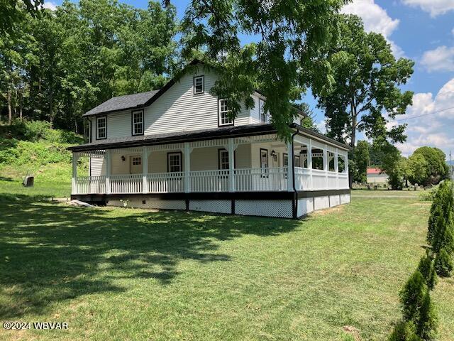 view of front facade with covered porch and a front yard