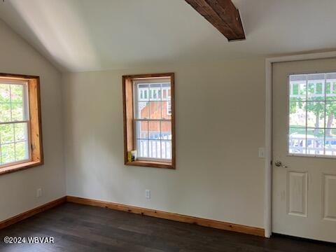 empty room featuring dark wood-style floors, a wealth of natural light, and vaulted ceiling with beams