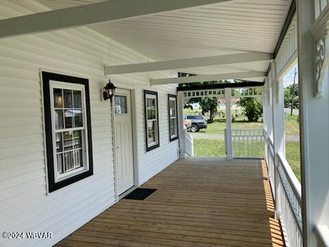 wooden terrace with a porch