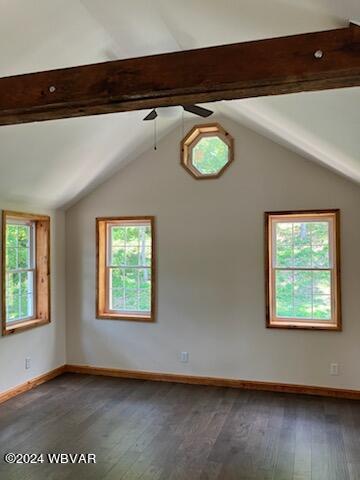 spare room with vaulted ceiling with beams, wood-type flooring, and baseboards