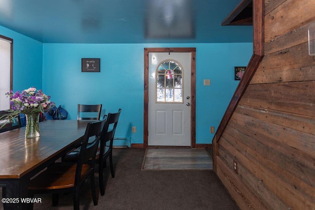 entryway featuring dark carpet and a baseboard radiator