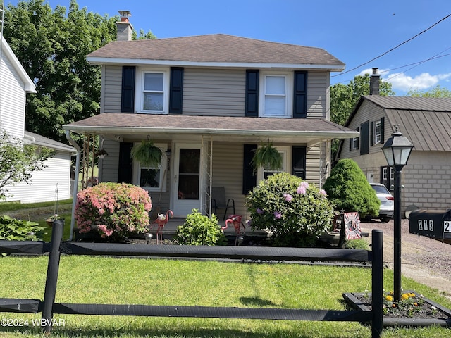 view of front of home with a porch and a front lawn