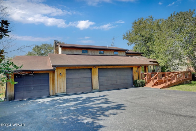 view of front of house featuring a garage and a deck