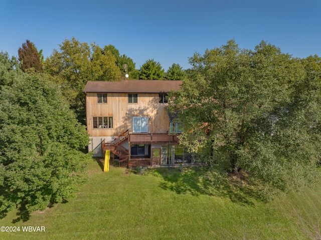 rear view of house with a lawn and a deck