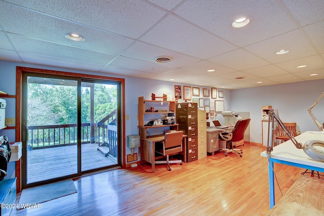 home office with a drop ceiling and wood-type flooring