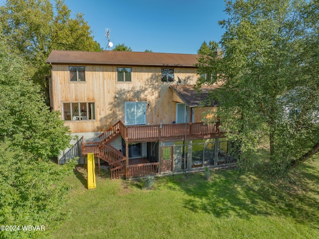 rear view of house featuring a yard and a wooden deck