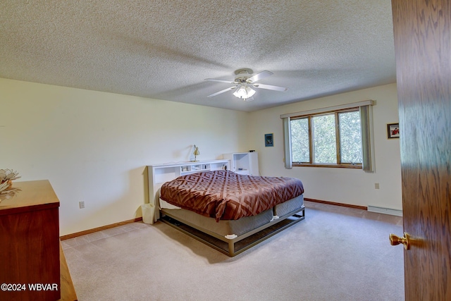 bedroom with baseboard heating, ceiling fan, light colored carpet, and a textured ceiling