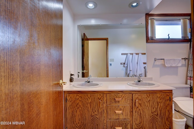 bathroom featuring vanity and toilet