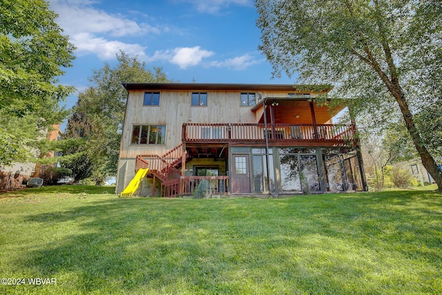 back of house featuring a deck and a lawn