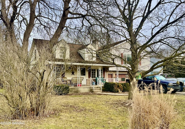 rear view of property with a porch