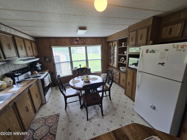 446 State St, Jersey Shore, PA 17740 - kitchen with white appliances, wooden walls, and open shelves