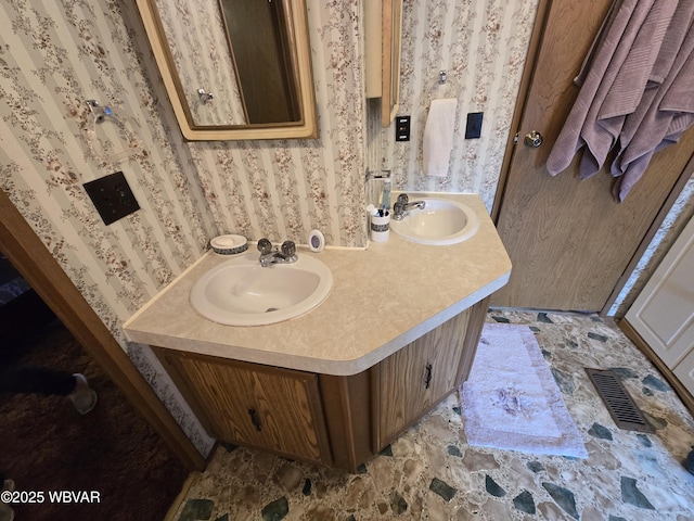446 State St, Jersey Shore, PA 17740 - bathroom featuring wallpapered walls, double vanity, and stone finish floors