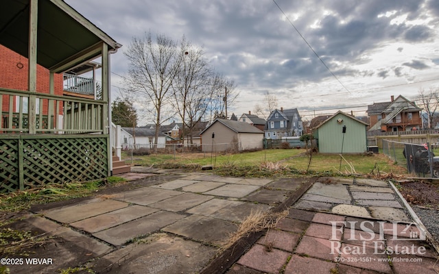 view of patio featuring a shed