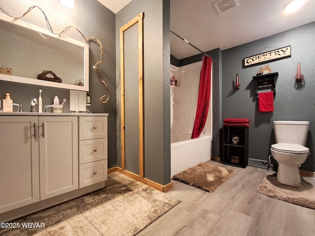 442 Mcelhattan Dr, Lock Haven, PA 17745 - bathroom featuring a textured wall, wood finished floors, shower / bath combination with curtain, and vanity