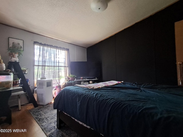 442 Mcelhattan Dr, Lock Haven, PA 17745 - bedroom featuring a textured ceiling, vaulted ceiling, and wood finished floors