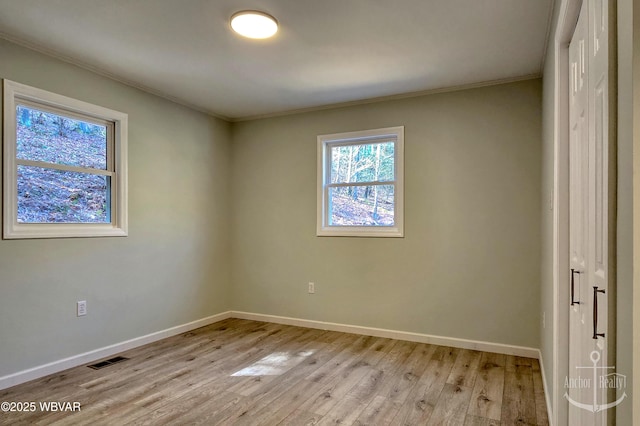 77 Yost Rd, Mill Hall, PA 17751 - spare room featuring light wood finished floors, baseboards, ornamental molding, and visible vents