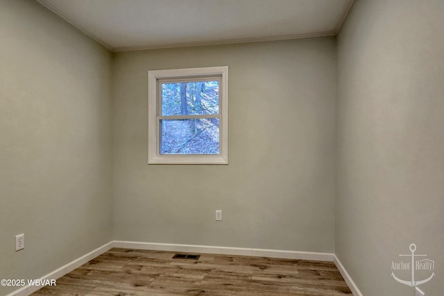 77 Yost Rd, Mill Hall, PA 17751 - empty room featuring visible vents, baseboards, ornamental molding, and wood finished floors