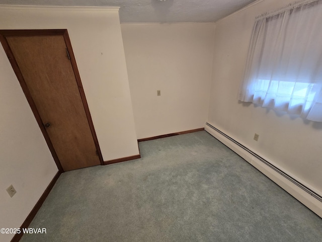 carpeted spare room with a textured ceiling and a baseboard heating unit