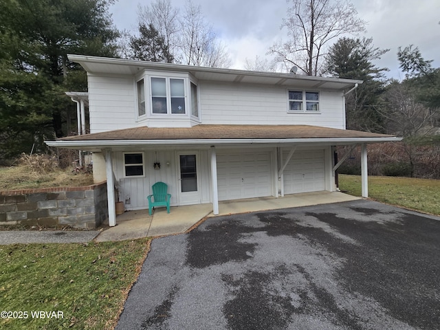 view of front of property with aphalt driveway, a porch, and a garage