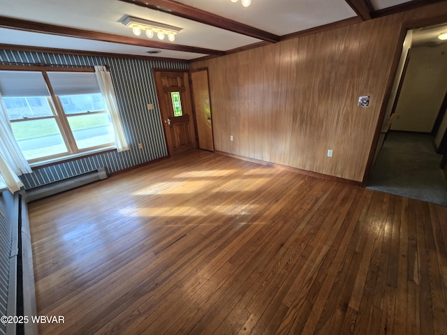 interior space featuring beamed ceiling, hardwood / wood-style floors, and baseboard heating