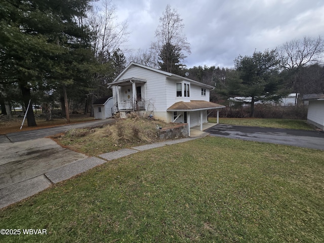 view of front of home featuring a front lawn and aphalt driveway