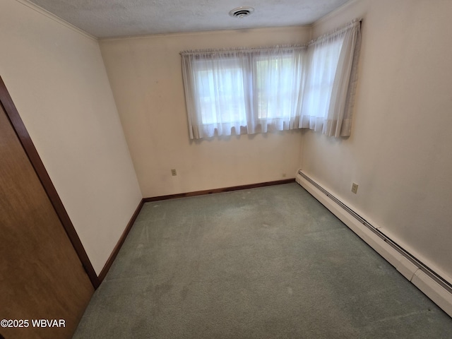 unfurnished room with visible vents, baseboard heating, carpet flooring, a textured ceiling, and baseboards